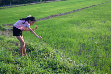 a girl playing and happy on green field