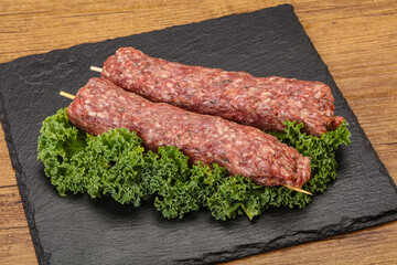 Raw minced beef kebab skewer