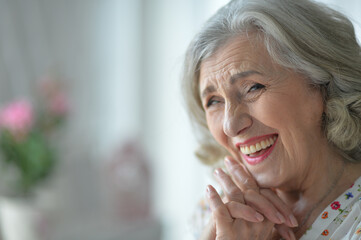 Portrait of happy senior woman posing at home
