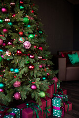 Close up Christmas tree decorated and gift boxes. No people. Home comfort of modern house.