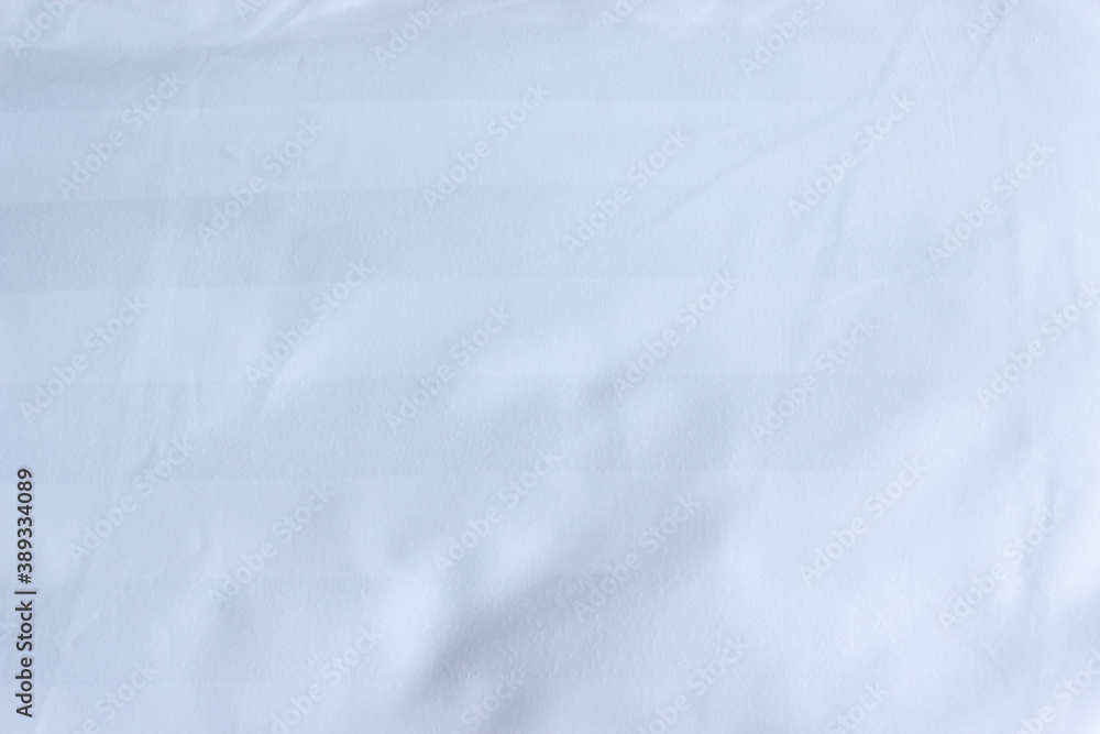 Sticker Top view of white fabric bed sheet with pillowcases texture background.