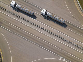 Aerial top down shot of highway with oil truck trailer.