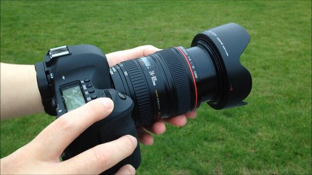 Before the photographer takes pictures with DSLR camera with green grass background