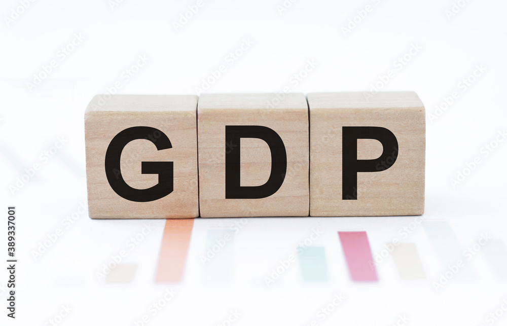 Poster text gdp on wood cubes on on a white background with graphs, economic data concept.