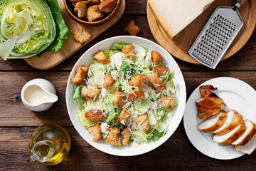 Classic caesar salad with grilled chicken fillet and parmesan cheese. top view	 - 389337028