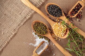 Various raw lentils with rosemary, salt and pepper.