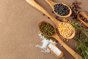 Various raw lentils with rosemary, salt and pepper.