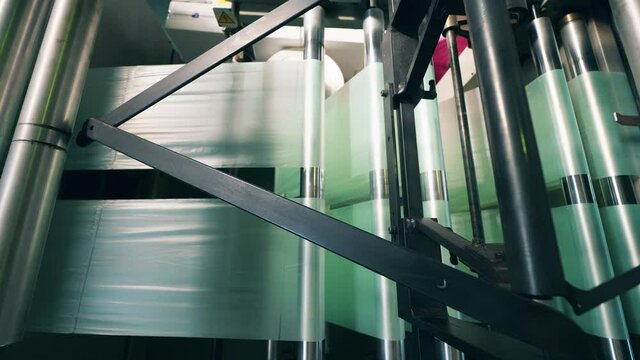 Factory rolling machine with polyethylene going through it