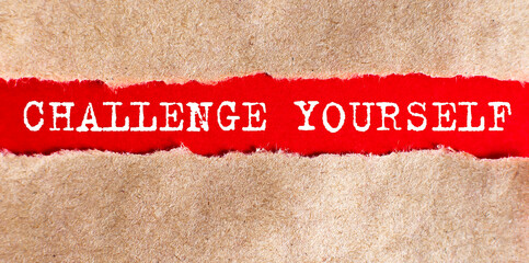 Challenge Yourself appearing behind torn paper. Business