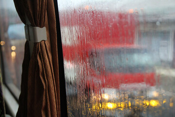 Raindrops on the side mirror of the bus. Focus selected. Background blur