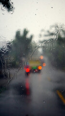 Raindrops on the windshield of the car. Focus selected. Blur background