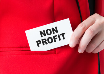 Businessman putting a card with text Non Profit in the pocket