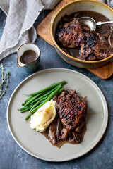Cock au vin, French dish of chicken braised in wine with mashed potatoes and green beans