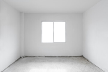 Concrete cement floor with white wall and window. Under construction empty room interior
