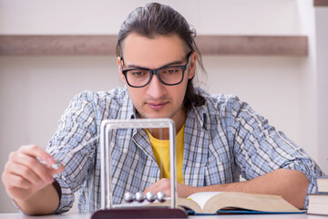 Young male student preparing for exam at home