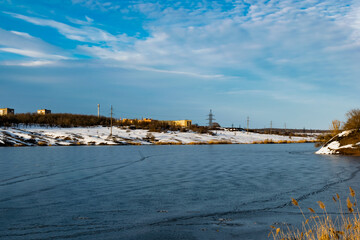 Spacious snow landscape. River and hills in Russia, white winter on the terrain, a lot of fluffy snow and ice under a beautiful blue sky. Rostov region, town of Shakhty, the river Grushevka