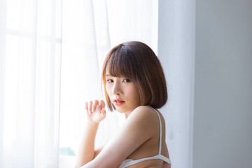 Naklejka premium Portrait asian young woman wearing sexy bikini in bedroom
