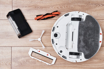 Repair robot vacuum cleaner, closeup. Household appliance service