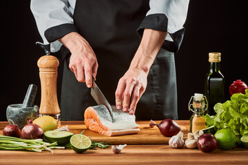 Man cutting salmon into steaks on wooden board