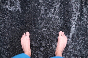 Feet on the black sand