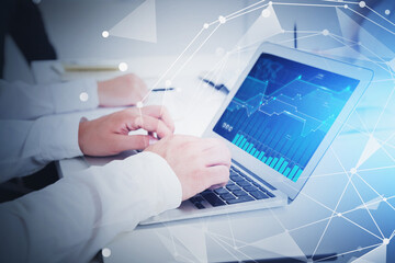 Man using laptop in office, diagrams