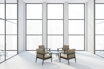 Fototapeta premium Armchairs in a bright white room in business office building with big windows