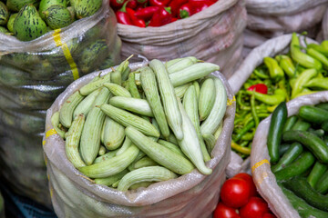 top view, fresh vegetables standing in sack at market place.