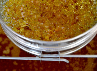 Drop of bee honey drip from hexagonal honeycombs