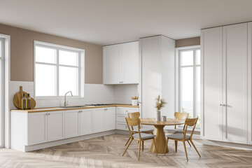 White kitchen corner with cupboards and table