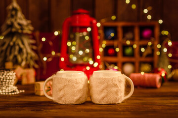 Beautiful multi-colored Christmas decorations on a wooden table with garlands and Christmas trees