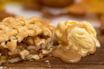 Autumn mini apple pie with lattice, ice cream, caramel sauce and leaves