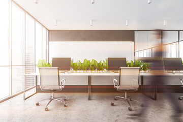Man walking in white and gray open space office