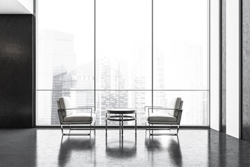 Two white chairs against each other in business lobby, view on city with skyscrapers