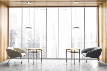 White and grey chairs with coffee tables, near a big tall window with city view