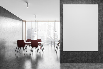 Mockup canvas in a dark grey office room, red chairs with tables on a dark floor