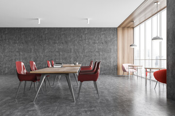 Grey office room, wooden tables and red chairs on marble floor. Minimalist office room
