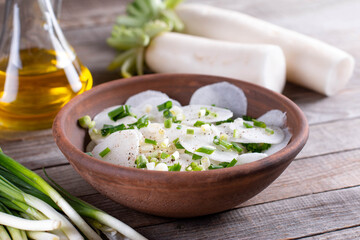 Daikon radish salad with fresh onion, pepper, sea salt and oil