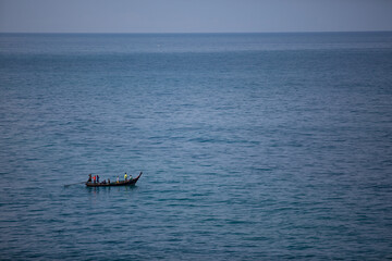 
A small boat in the middle of the blue sea