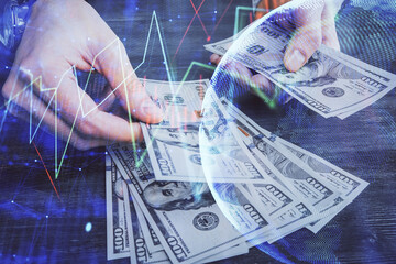 Multi exposure of financial graph drawing hologram and USA dollars bills and man hands. Analysis concept.