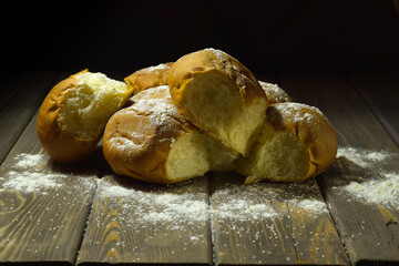 freshly baked buns lie on a wooden table