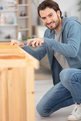 man putting together self assembly furniture