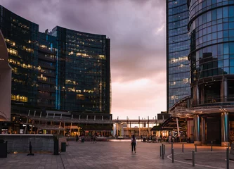 Fotobehang People walking during sunset in Gae Aulenti square, in the new Porta Nuova district in Milan © Jan Cattaneo