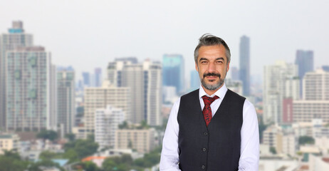Fototapeta na wymiar Senior Caucasian businessman with formal wear standing with cityscape in urban panorama view with copy space