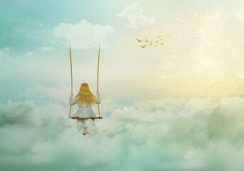 Lonely girl sitting on the swing above clouds; fantasy/solitude/surreal background with copy space