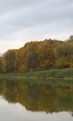 Fototapeta na wymiar autumn landscape with lake and reflections 