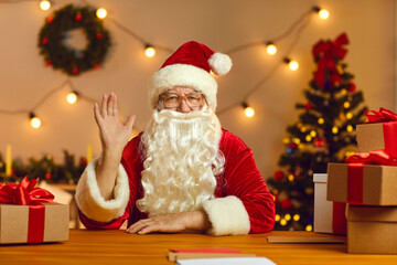 Santa Claus waving hand during video call or greeting his subscribers on his live stream