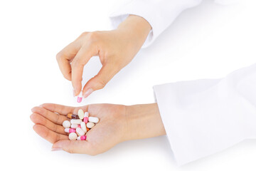 gesture of hand taking a pill from the other palm which contains a group of medicines on white background