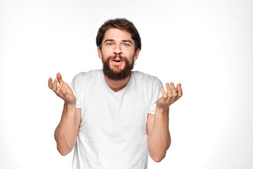 Bearded man in white t-shirt gesture with hands emotions light background