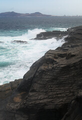 North coast of Gran Canaria, lava fields of Banaderos area, grey textured lava from eruption of Montana de Arucas, 
stormy weather in October