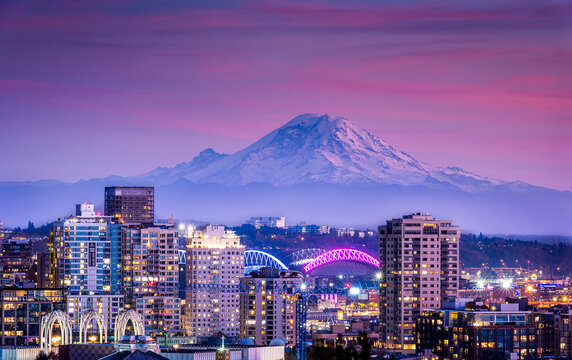 beautiful city scape with mountain and colorful sky at sunset
